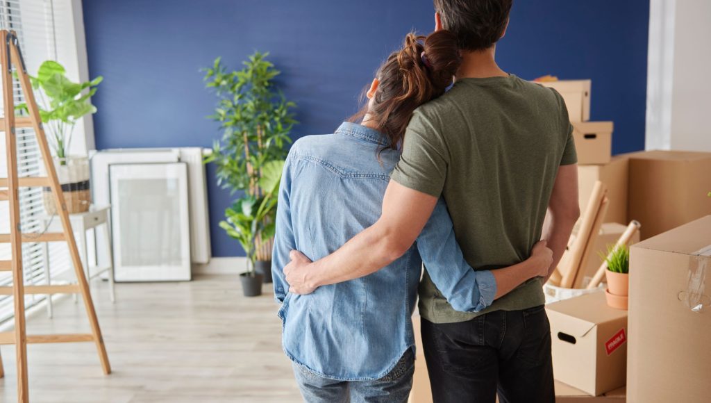 Couple hugging in their new home, financed by Onward Mortgage